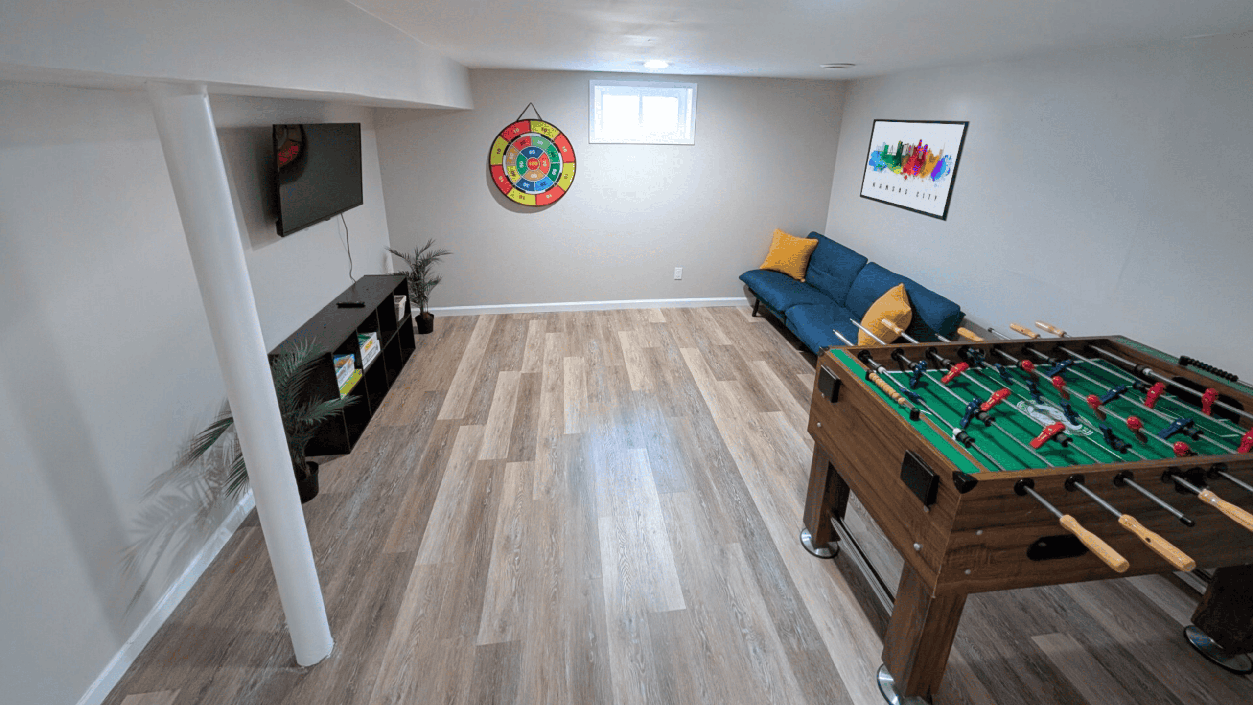 Dining Room Lees Summit Interior of a game room with foosball table, TV, and comfortable seating.